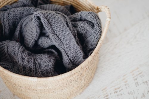 gray throw blanket in basket