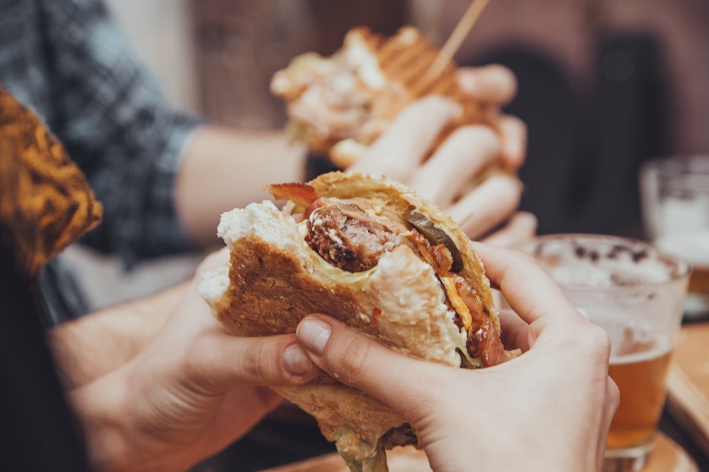 woman eating a bacon cheeseburger ways we're healthier