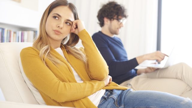 woman ignoring a man on a couch