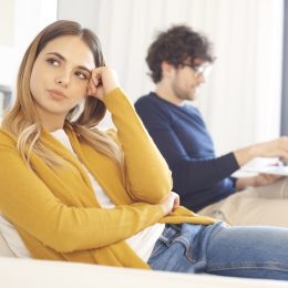 woman ignoring a man on a couch