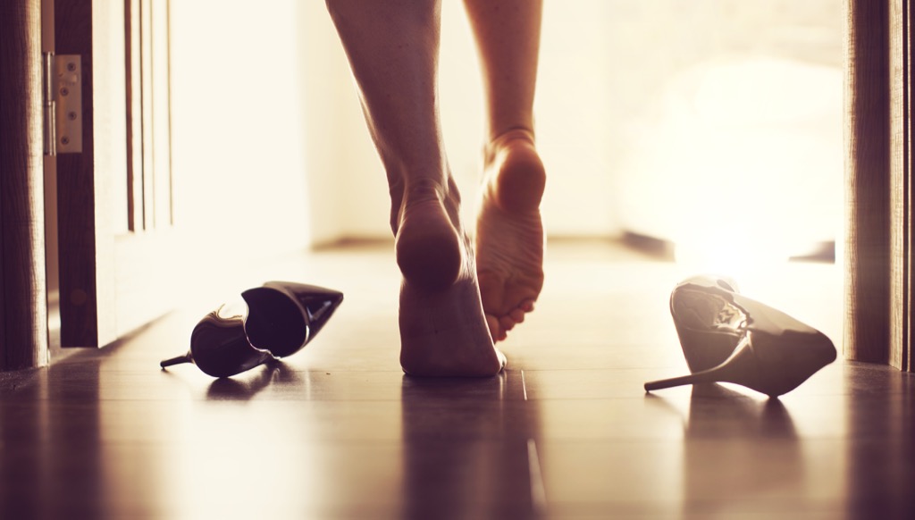 barefoot woman walking into bedroom
