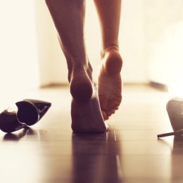 barefoot woman walking into bedroom