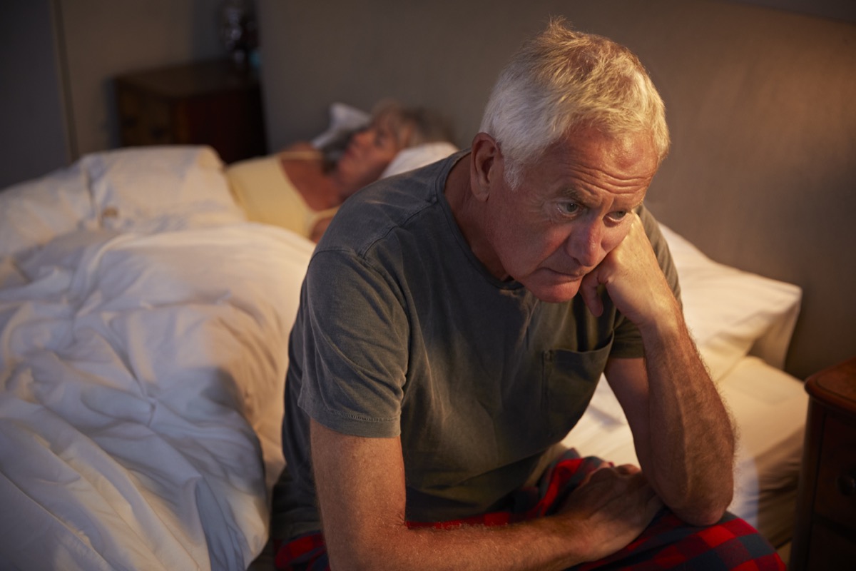 Man stressed in bed