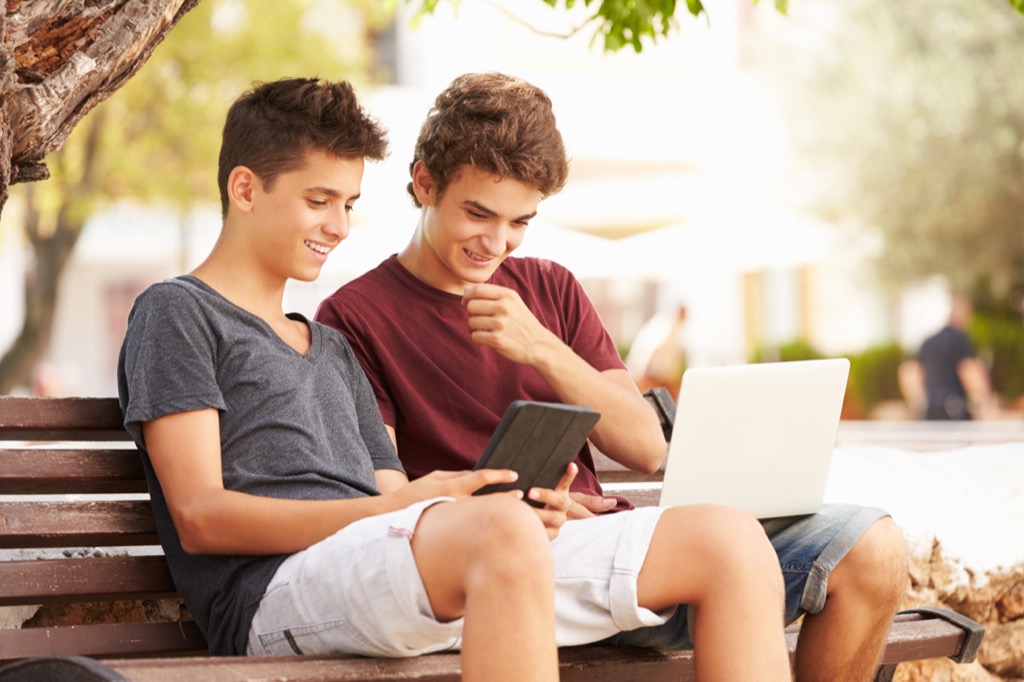 teen boys using laptops
