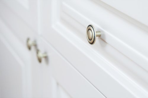 silver drawer pulls on white cabinet