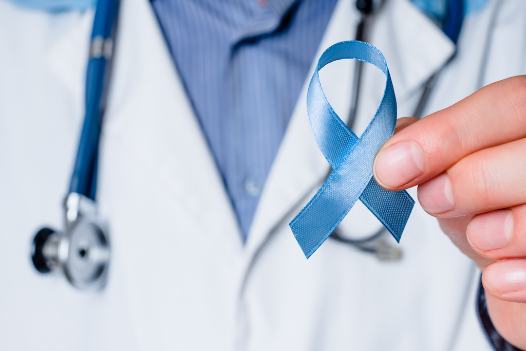 doctor holding prostate cancer ribbon men's health concerns over 40