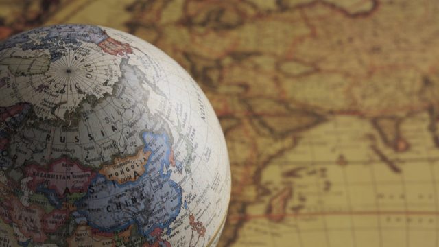 a globe and a map National Geographic bee