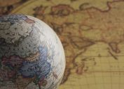 a globe and a map National Geographic bee