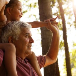 grandparent and grandchild in the woods
