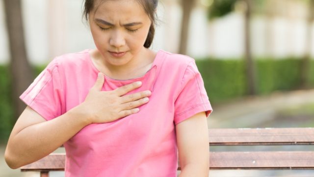 woman with hand over heart, ways you're damaging teeth