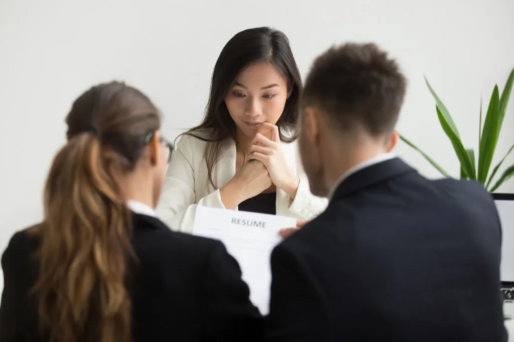 people reading resume at interview