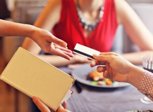 man paying for dinner with a credit card