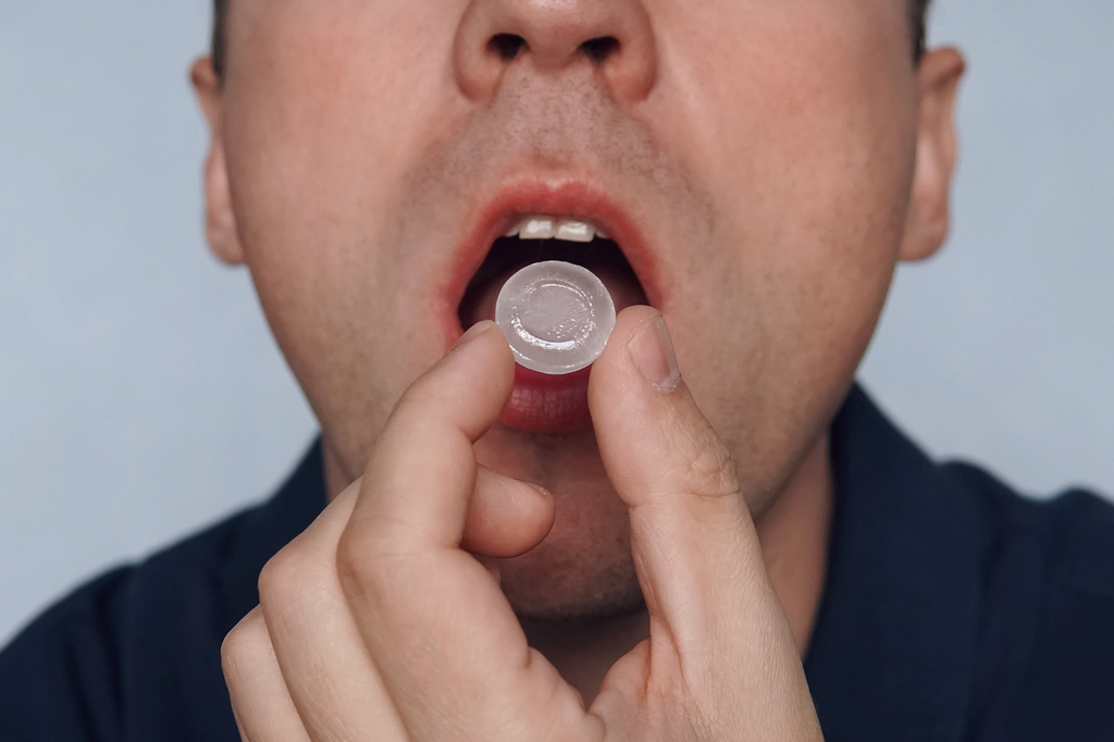 Man Sucking on Cough Drop, bad for your teeth