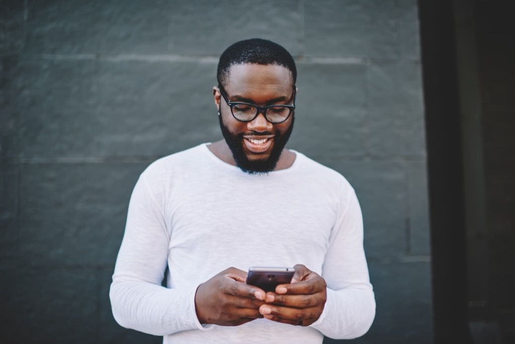 man texting on smartphone