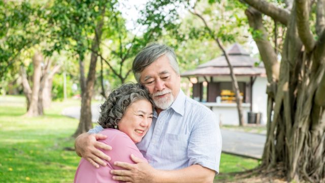 older couple hugging outdoors, better wife after 40