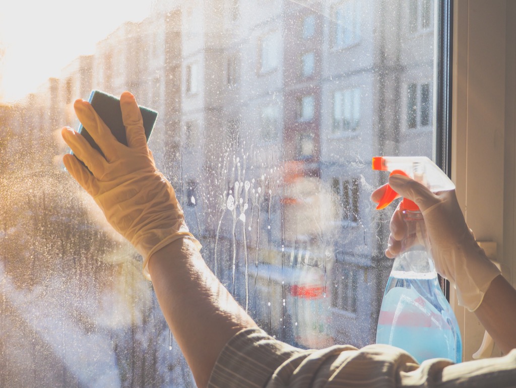person cleaning a glass window, easy home tips