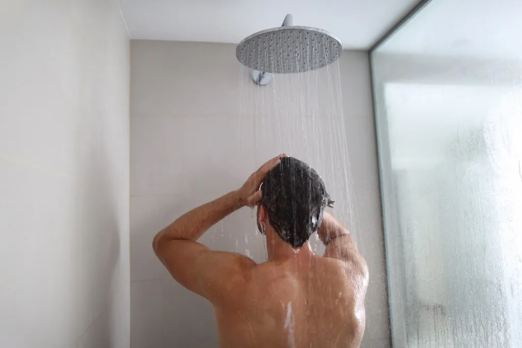 man showering under rainfall showerhead, home upgrades