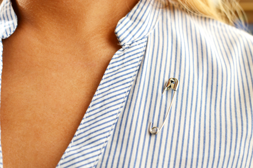safety pin on a woman's shirt