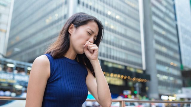 woman coughing on the street