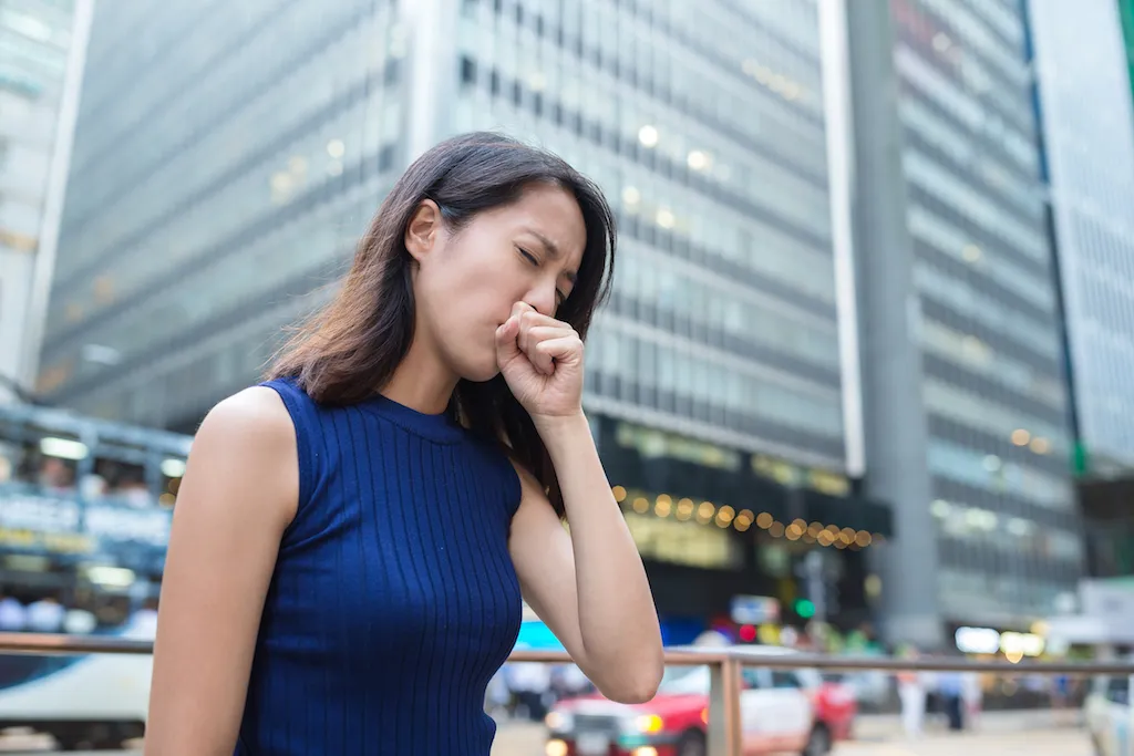 woman coughing on the street weird town names