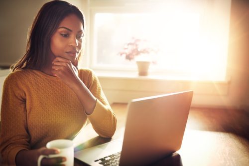 thoughtful woman on computer, stay at home mom