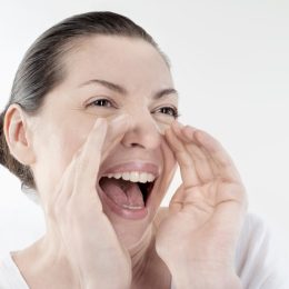 Mature woman shouting and screaming isolated over white background