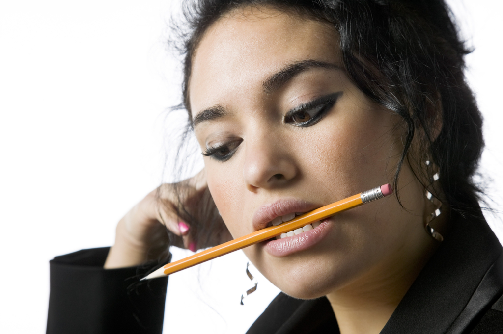 Woman with Pencil in Mouth Things That Would Horrify Your Dentist