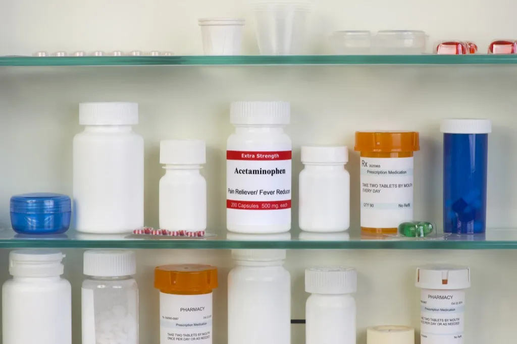 acetaminophen and other pill bottles in a medicine cabinet