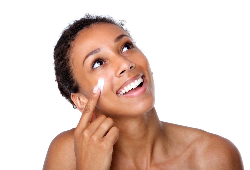 woman applying face lotion