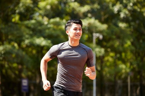 Asian man going for a run outside