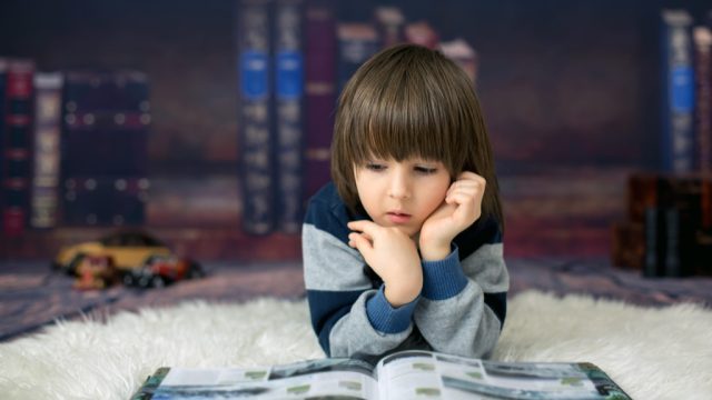cute kid in home library