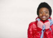 black woman in puffy coat smiling