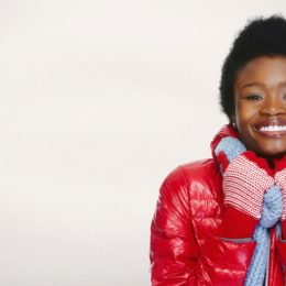black woman in puffy coat smiling