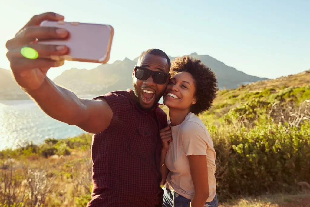 man and woman on vacation taking selfie