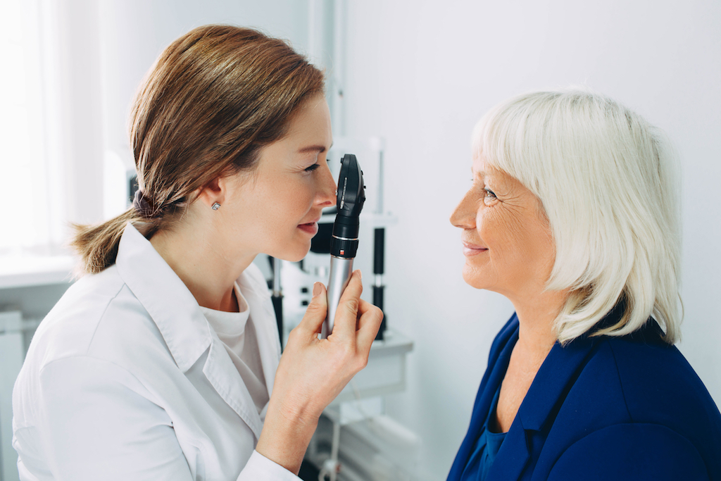 older woman getting eye exam, subtle symptoms of serious disease