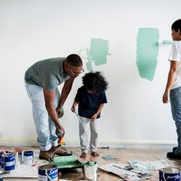 family painting a living room wall