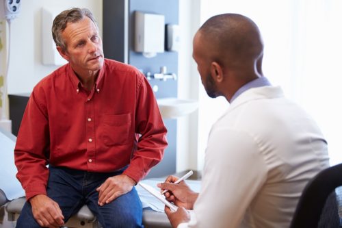 man getting bad news at a doctor checkup, heart risk factors