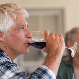 Mature man drinking a glass of red wine