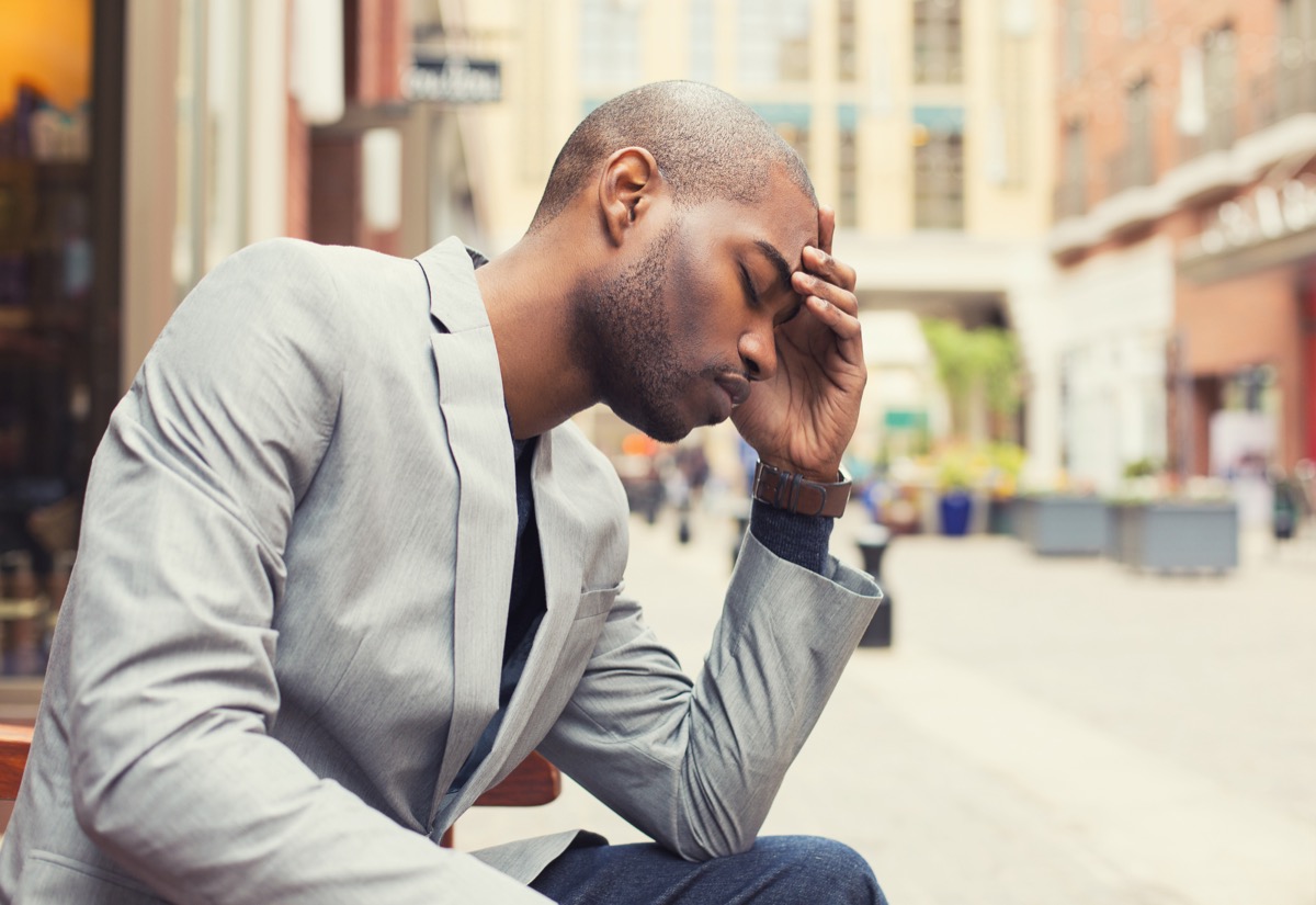 Man Holding His Head With a Headache Silent Health Symptoms