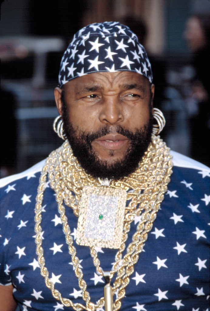 Mr. T Wears blue and white star bandana and gold chains with gold hoops, an icon of 80s fashion