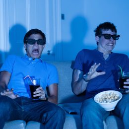 Two boys scared watching a scary movie