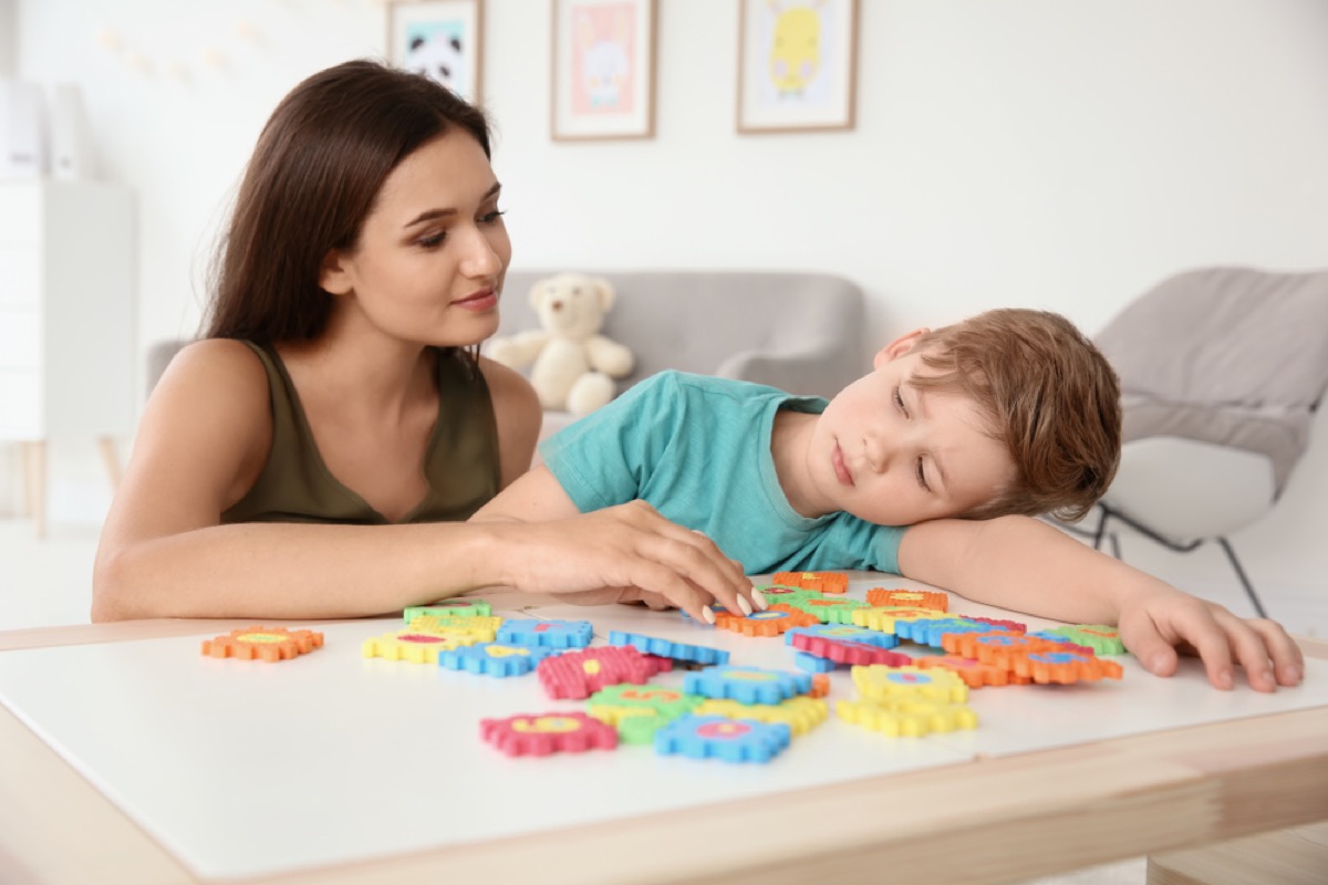 white woman playing with autistic son
