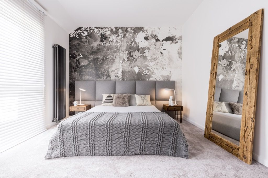 small well designed monochromatic modern bedroom with a wooden mirror against the wall, Joanna Gaines tips