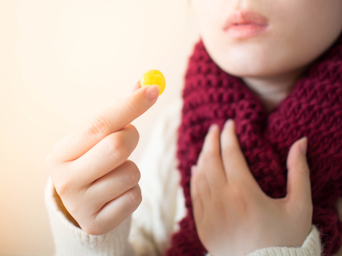 Woman Using a Throat Lozenge For Her Sore Throat {Common Cold Treatment}