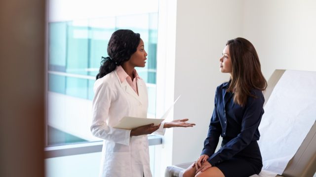 doctor talking to a female patient at a checkup