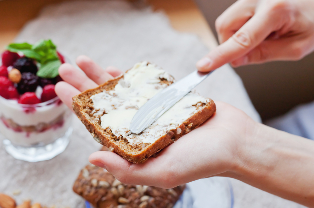 Woman Eating Whole Grain Bread Habits That Increase Flu Risk