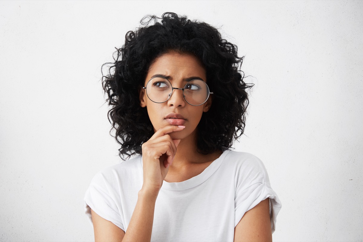 Woman in glasses pondering thinking
