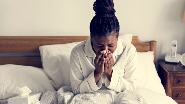 woman sick in bed exposed to serious flu risk