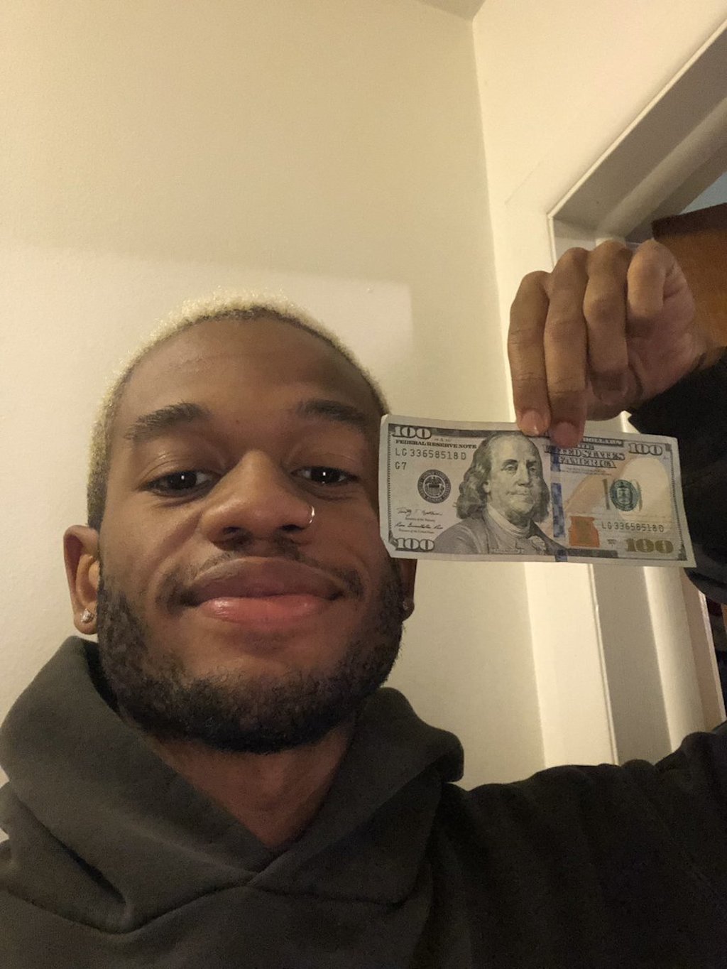man with hundred dollar bill