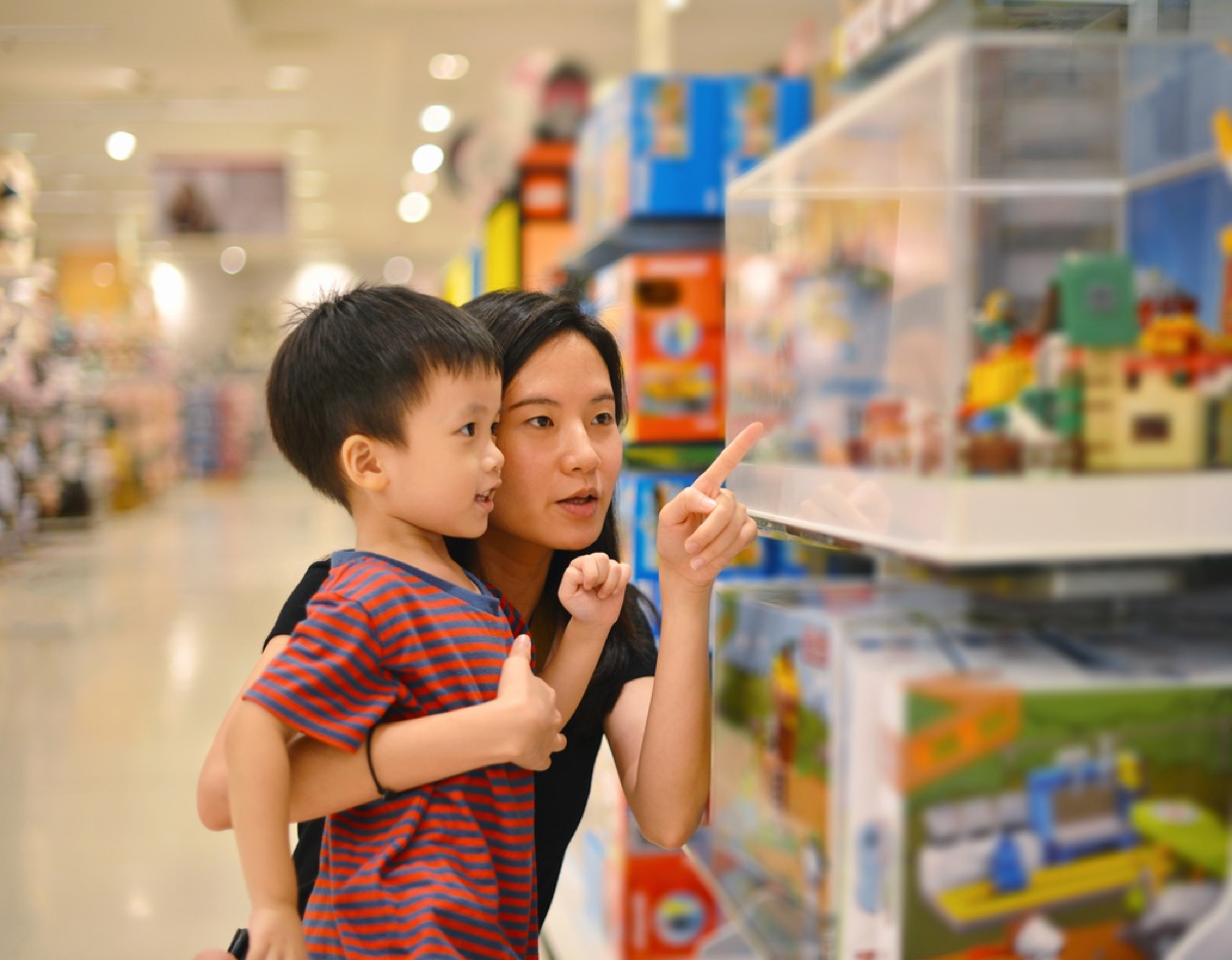 asian mom and son shop at toy store